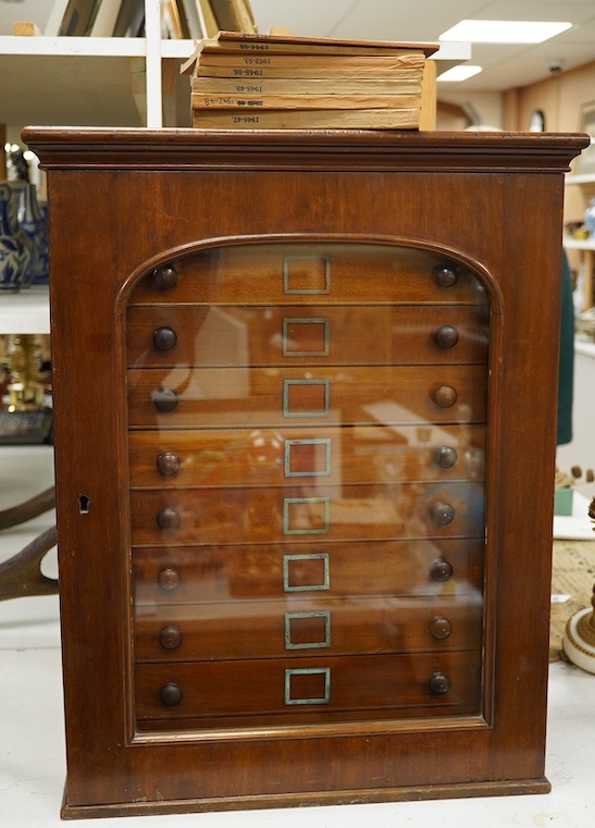 A Victorian mahogany 10-drawer collector’s cabinet with arched glazed door, height 68cm, width 54cm, depth 53cm, containing prepared and pinned moth and butterfly specimens, together with seven 1940s volumes of the Proce